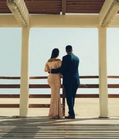 man and woman standing on wooden dock during daytime